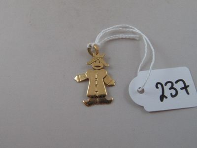 a gold ornament that has a small boy on it