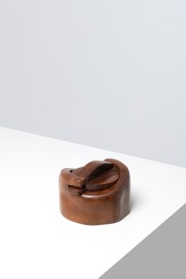 an image of a small wooden object on a white surface