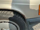 a close up of a car ' s tire with a shadow on the ground