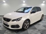 a white car is parked in a room with a checkered floor