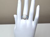 an image of a woman ' s hand with a ring on it