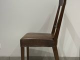 chair made of wood and leather in the style of person