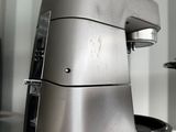 a silver mixer sitting on a counter in a kitchen