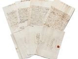 several pieces of old paper with writing on them on a white surface