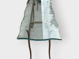 a glass table with a glass top and a metal stand