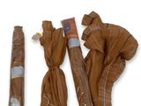 three umbrellas that are wrapped in plastic and tied together
