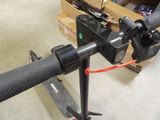 a close up of a bike handle with a box in the background