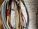 a rope that is hanging on the wall next to a bunch of tools