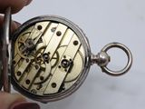 a close up of a pocket watch being held by a person