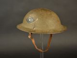 an old helmet on a stand on a black background