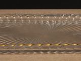 an image of a clear glass tray with yellow beads on it