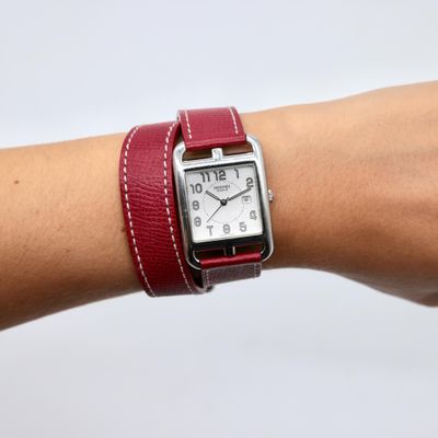 a woman ' s wrist that has a watch on it