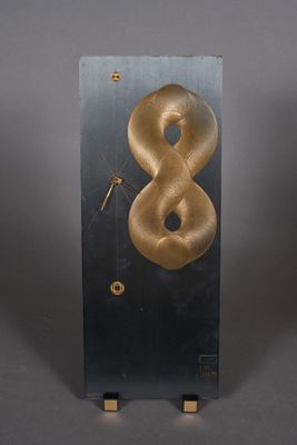 a clock that has a gold snake on it
