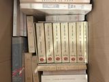 a box full of books sitting on top of each other