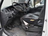 a white van with the door open and the driver ' s seat down