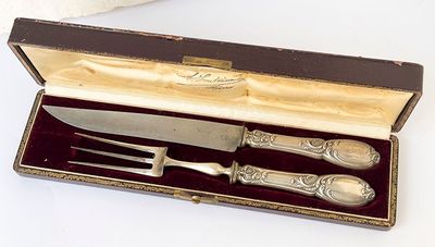 a knife, fork and spoon in a box on a table