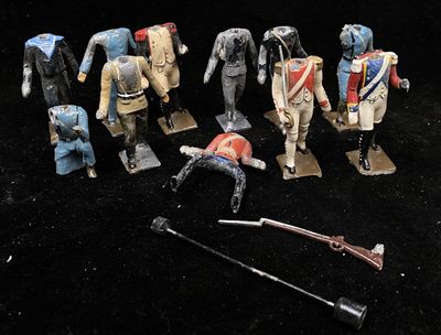 a group of toy soldiers that are on a black surface