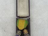 an image of a medal in a case on a white surface