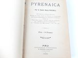 a book opened on a white surface with a black and white title