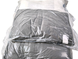 two pillows that are wrapped in plastic on top of each other