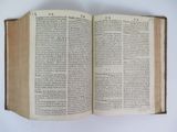 an open book on a table with a white background