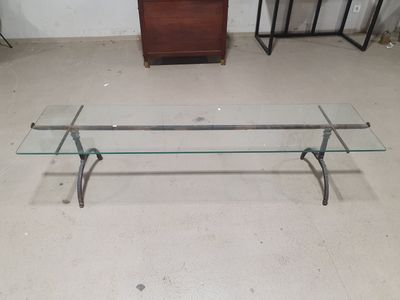 a glass table with a glass top and metal legs