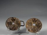 a pair of chinese bronze coins on acrylic bases