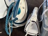 a white and blue iron sitting on top of a table