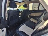 the interior of a car with the door open and the passenger seat up