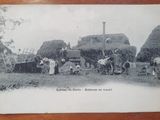 an old black and white photo of a group of people working on a farm
