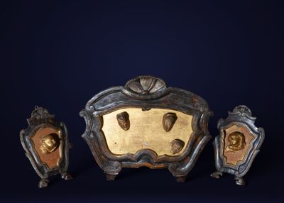 three pieces of art that are sitting on a table