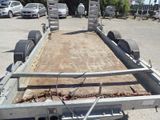 a trailer with a flat bed in a parking lot
