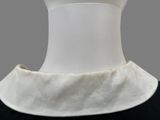 collar of a mannequin wearing a black dress with a white collar