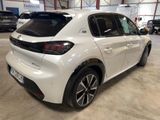 the rear end of a white car parked in a garage