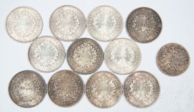 several different types of coins are arranged on a white surface