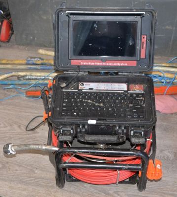 a laptop computer sitting on top of a cart on the floor