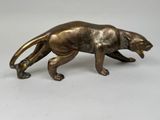bronze figurine of a panther on a white background