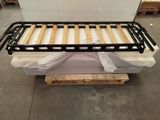 a bed that is sitting on a pallet in a warehouse