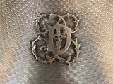 a silver vase with a monogram on it