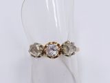 a close up of a ring with a diamond on top of a clear ring