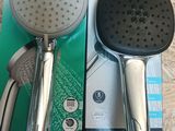 two shower heads and a shower head in the box