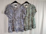 two women ' s tops on a hanger against a white curtain