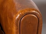 an image of a brown leather couch with a wooden frame