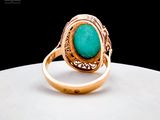 an image of a gold ring with a turquoise stone in it