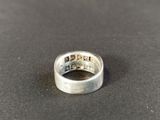 a close up of a silver ring on a black surface