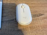 a computer mouse sitting next to a laptop on a desk