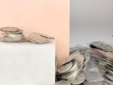 a box of coins sitting next to a pile of coins