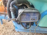 a small engine that is attached to the back of a truck