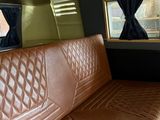 a brown leather couch in the back of a bus