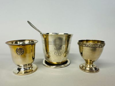 three silverplated cups and spoons on a white surface
